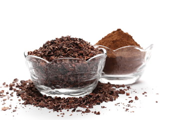 Chopped and powder cocoa pile in glass bowl isolated on white background