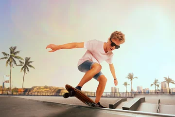 Rolgordijnen Skateboarder is performing tricks in skatepark on sunset. © VIAR PRO studio