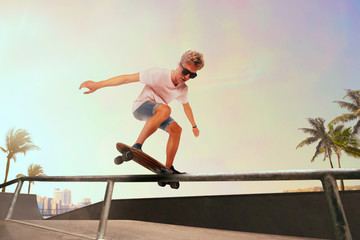 Fototapeta na wymiar Skateboarder is performing tricks in skatepark on sunset.