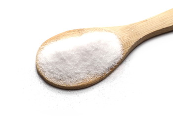 Pile sea salt in wooden spoon isolated on white background