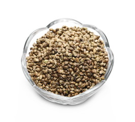 Hemp seeds in glass bowl isolated on white background