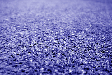Artificial grass with blur effect in blue tone.