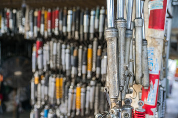Many old shock absorbers hanging at a repair shop on Hanoi street, Vietnam