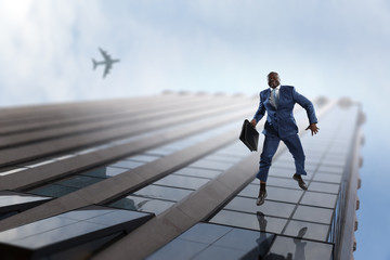 Black businessman walking on modern corporate building facades