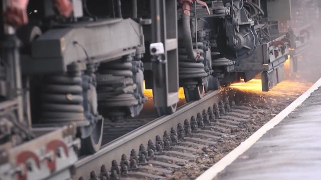 from under the car of a train sparks