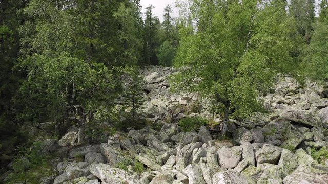 aerial view of Taganay national park in Russia. drone flying over big stone river - amazing and impressive natural formation. wonder of nature is an evenly conglomeration of huge rocky flinders