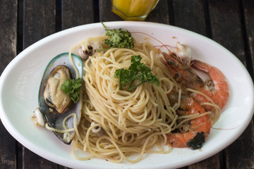 Seafood and pasta,sicily,spaghetti on a black wood table