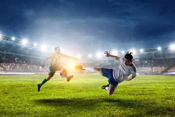 Obraz na płótnie Canvas Two football players on stadium in action