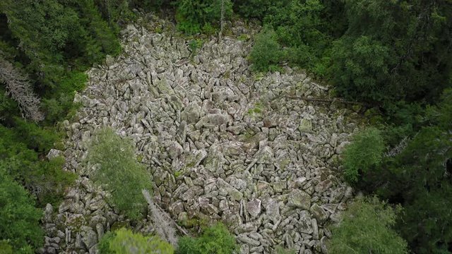 aerial view of Taganay national park in Russia. drone flying over big stone river - amazing and impressive natural formation. wonder of nature is an evenly conglomeration of huge rocky flinders