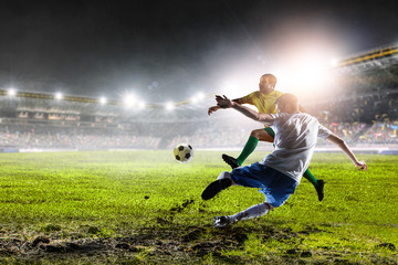 Fototapeta na wymiar Two football players on stadium in action