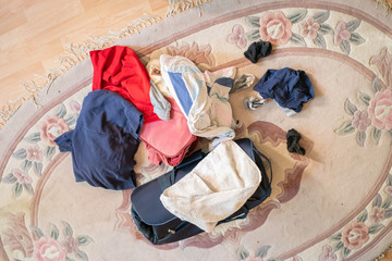 mess of many things and clothes on the floor at home before the journey start