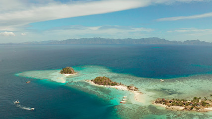 Naklejka na ściany i meble aerial seascape island with white beach. Bulog Dos, Philippines, Palawan. tourist boats on coast tropical island. Seascape bay with turquoise water and coral reef.