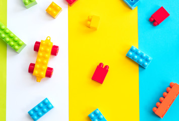 Plastic toy blocks on color background