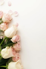 Flowers composition background. beautiful pink roses and petals on white     background.Top view.Copy space