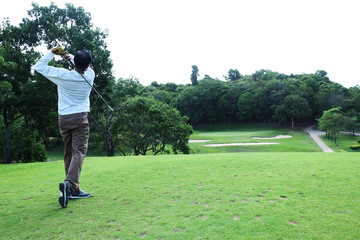 Asian golfer hit a golf ball by golf-club driver at golf course