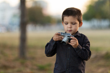 toddler boy with old retro vintage camera