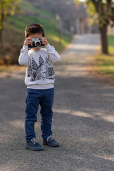 Boy With Retro Camera in Park