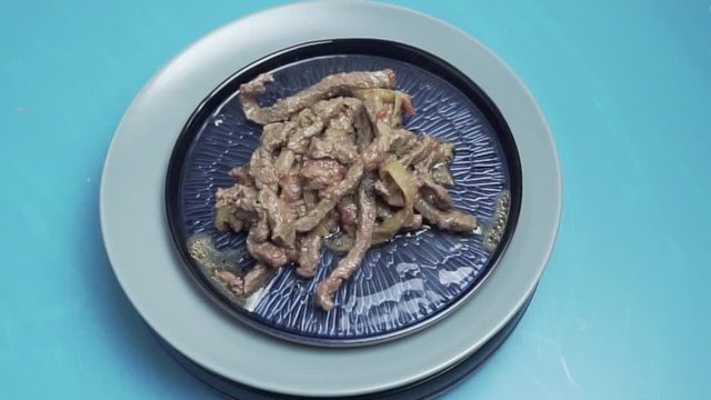 Beef fajitas in blue plate rotating