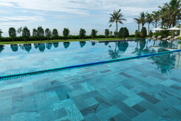 Swimming pool at tropical villa resort by the sea