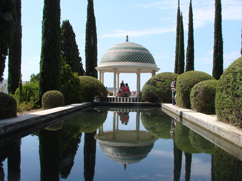templete con cipreses reflejados en estanque jardin botanico la concepcion malaga