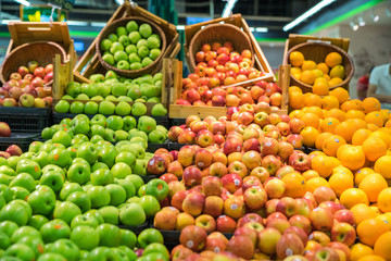 Fresh healthy fruits on shelves in supermarket