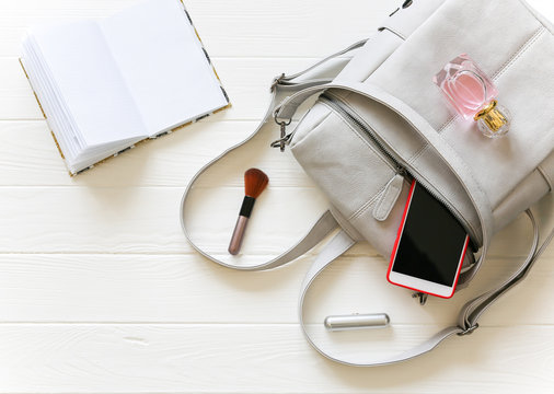 Phone, Stylish Bag And Perfumes On White Background. Beautiful Flat Lay. Things For Business Woman. Note Book Schedule. Makeup Kit.