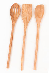 Top view of three wooden ladles on a white background