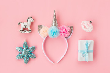 Set of various white and light blue Christmas details: gifts and toys on pink background. Top view, flat lay.