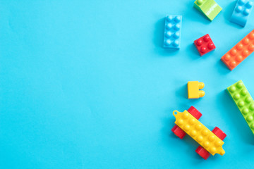 Plastic toy blocks on blue background