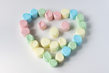 Sweet heart made of marshmallows on a white background. Marshmallow figures.