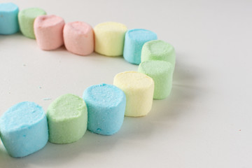 Sweet heart made of marshmallows on a white background. Marshmallow figures.