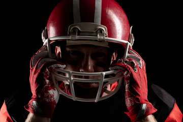 American football player standing with rugby helmet