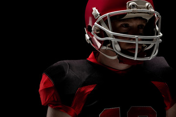 American football player standing with rugby helmet