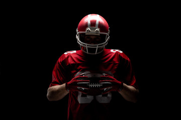 American football player standing with rugby helmet and ball - Powered by Adobe