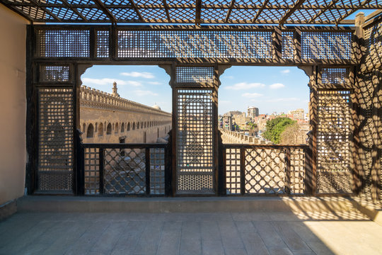 Passage surrounding the Mosque of Ibn Tulun framed by wooden window, Mashrabiya, Cairo, Egypt