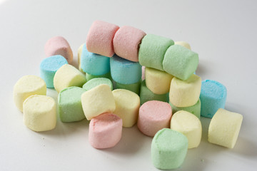 Colored marshmallows on a white background. A closeup of colored marshmallows.