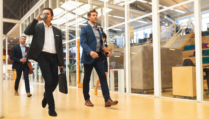Obraz premium Business people walking together in the corridor at office