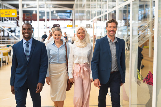 Business people walking together in the corridor at office