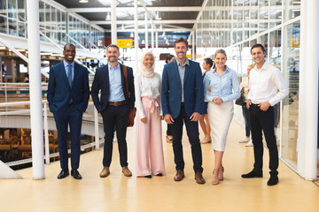 Business people standing together in corridor at office