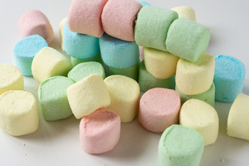 Colored marshmallows on a white background. A closeup of colored marshmallows.