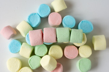 Colored marshmallows on a white background. A closeup of colored marshmallows.