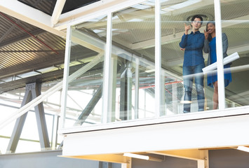 Male and female executive interacting with each other in office