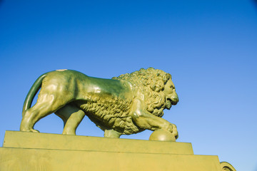 Fototapeta na wymiar Bronze lion figure on pedestal. St.Petersburg, Russia