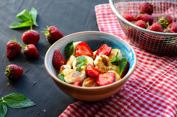 mini cheese pancakes with honey and strawberries on black background. proper nutrition healthy dessert