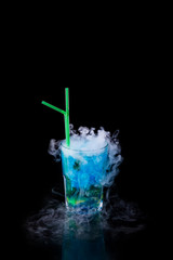 blue alcoholic cocktail with dry ice isolated