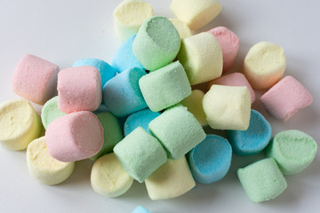 Colored marshmallows on a white background. A closeup of colored marshmallows.