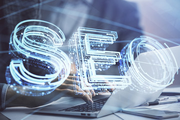 Double exposure of seo icon with man working on computer on background. Concept of search engine optimization.