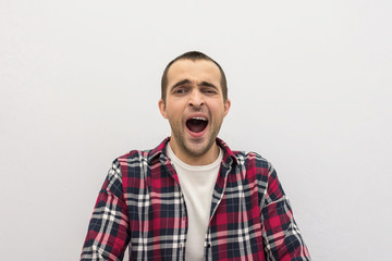 Obraz premium Handsome man yawns, portrait, front view, white background, copy space, advertising