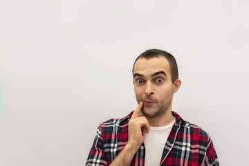 Indecisive man in casual clothes, he is uncertain, white background, copy space