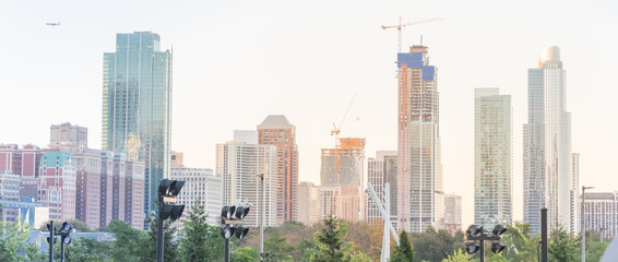 Panoramic building under construction with working cranes in downtown Chicago at sunset